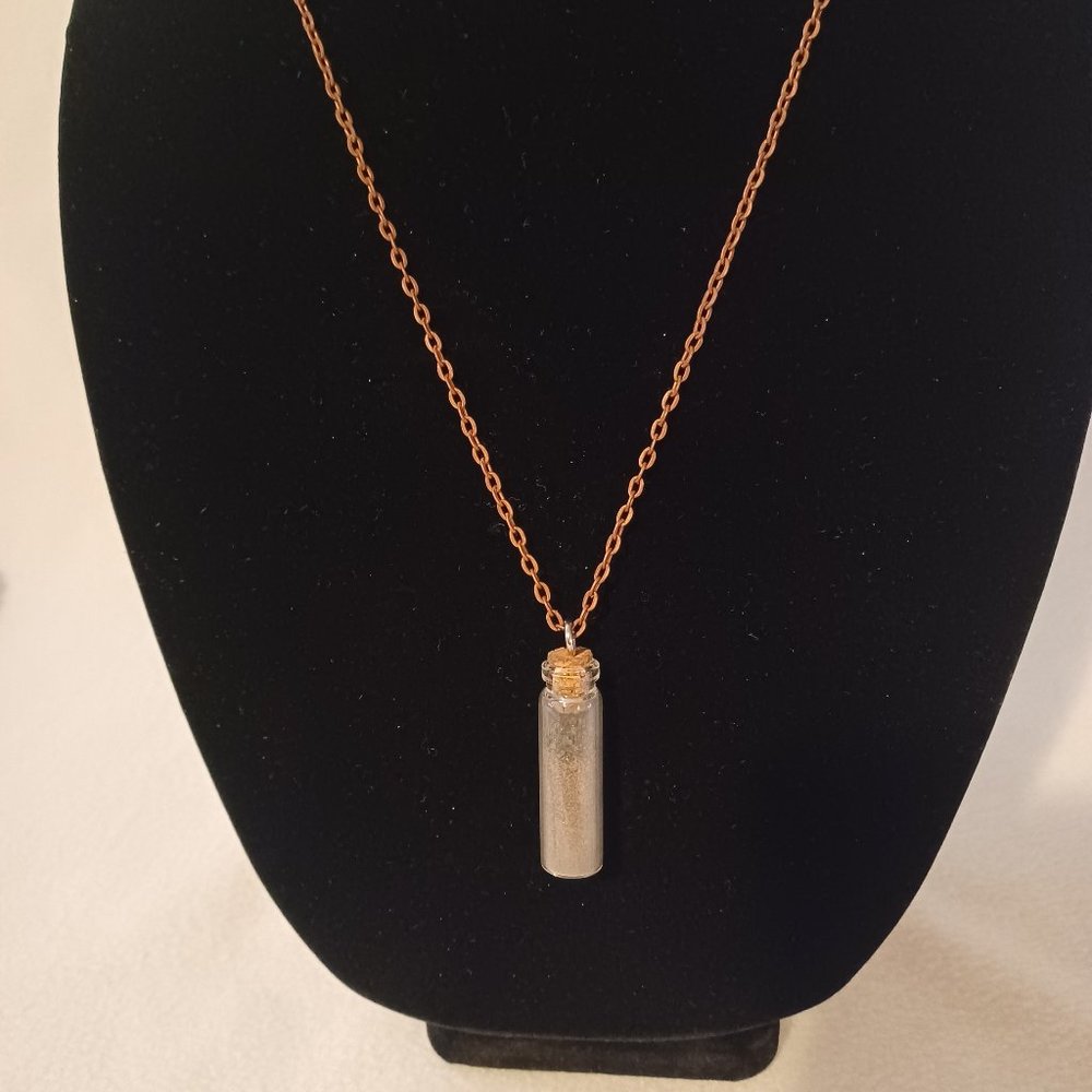 Bauxite filled vial with copper necklace